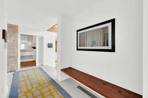 Mudroom with light tile patterned floors and baseboards