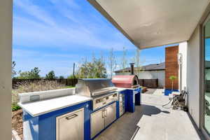 View of patio featuring exterior kitchen