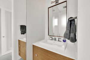 Bathroom with two vanities and light tile patterned flooring