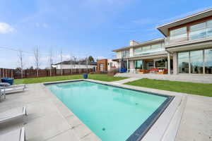 View of pool with patio surround and a fenced backyard