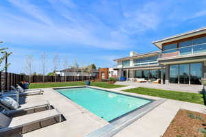 View of pool featuring patio surround, outdoor lounge area, and a fenced backyard