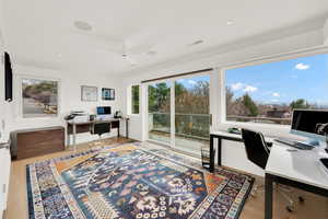 Home office featuring a ceiling fan and light wood-style floors