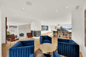 Living room featuring plenty of natural light, light wood finished floors, recessed lighting, and a ceiling fan