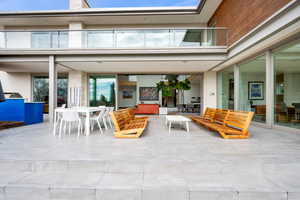 Patio / terrace with an outdoor living / dining area and a patio