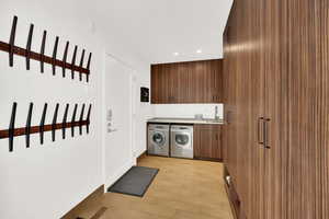 Laundry area with washing machine and clothes dryer, recessed lighting, and cabinet space