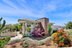 View of home's exterior with a sunroom