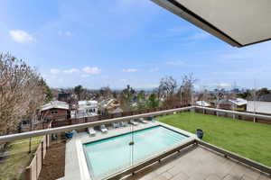 Balcony with view of pool area and a residential view
