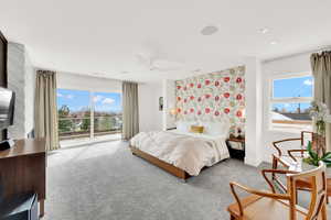 Carpeted bedroom with access to outside and a ceiling fan