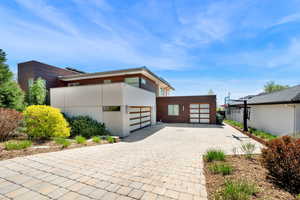 View of front of house featuring decorative driveway