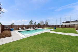 View of swimming pool with a fenced backyard and patio surround