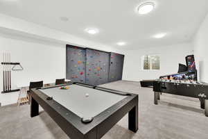 Playroom featuring light colored carpet and billiards