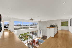 Hall featuring light wood-style floors and recessed lighting