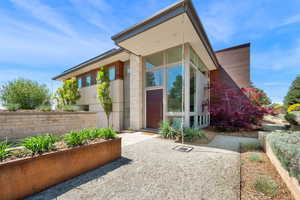 View of exterior entry with modern hardscaping