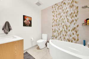 Full bath featuring vanity and washtub / shower combination