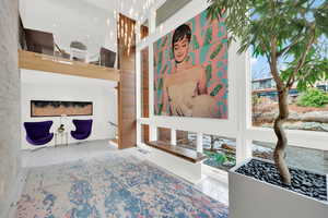 Entry with a high ceiling and light tile flooring