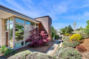 View of side of home with a sunroom