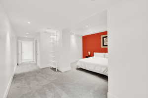 Bedroom with recessed lighting and light carpet