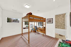 Bedroom featuring baseboards and an office area
