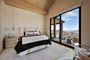 Bedroom with a mountain view, a vaulted wood ceiling, and access to outside
