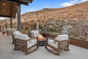View of patio / terrace featuring a fire pit, a mountain view, and an outdoor living / dining area