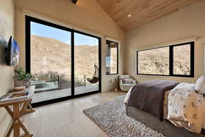 Bedroom featuring a mountain view, a vaulted wood ceiling, multiple windows, light wood-style flooring, and recessed lighting