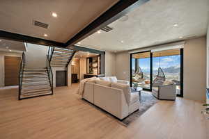 Living area featuring a mountain view, recessed lighting, and light wood-type flooring