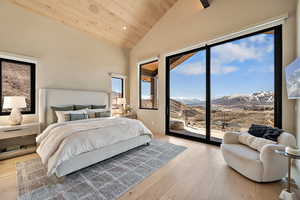Bedroom featuring a vaulted wooden ceiling, light wood-style flooring, recessed lighting, and access to exterior