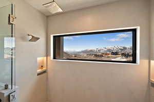 Bathroom view of a shower and a mountainous background