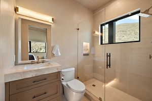Bathroom with a stall shower, vanity, and ensuite bathroom