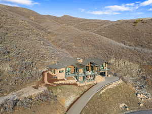 Aerial view of property and surrounding area featuring mountains