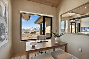 Office area featuring a mountain view, wood ceiling, and wood finished floors