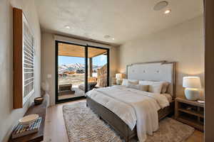 Bedroom featuring a mountain view, access to outside, light wood finished floors, and recessed lighting