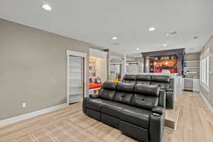 Living area featuring light wood-type flooring and recessed lighting