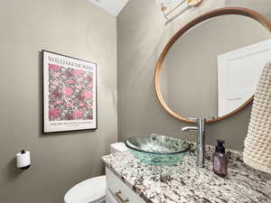 Half bath featuring vanity and toilet