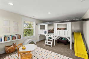 Bedroom with dark carpet and recessed lighting