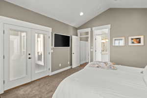 Bedroom with french doors, light carpet, connected bathroom, recessed lighting, and access to outside