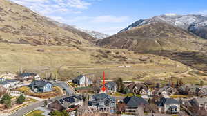 Aerial perspective of suburban area featuring a mountain backdrop