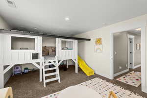 Bedroom with dark colored carpet