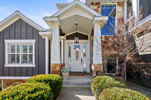 Property entrance with board and batten siding and stone siding