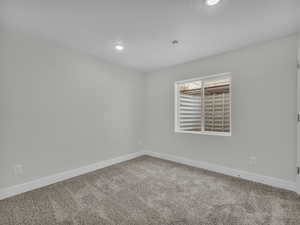 Empty room featuring carpet flooring and recessed lighting