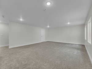 Spare room featuring light colored carpet and recessed lighting