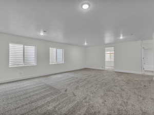 Unfurnished room with carpet floors and a textured ceiling