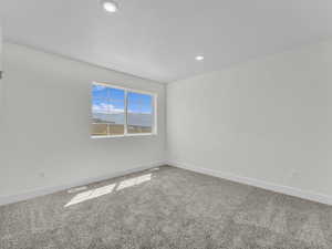 Unfurnished room with carpet and recessed lighting