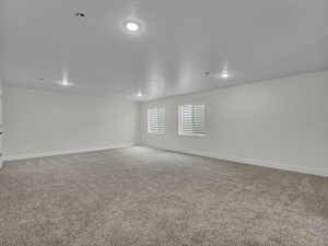 Unfurnished room with light colored carpet and a textured ceiling