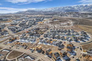 Aerial view of property's location with mountains and nearby suburban area
