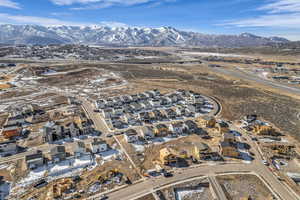 Aerial overview of property's location featuring a mountainous background and nearby suburban area