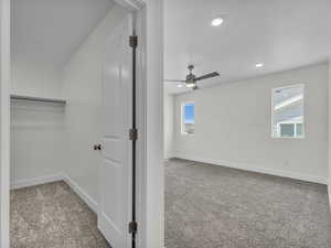 Empty room featuring light carpet, a ceiling fan, a textured ceiling, and recessed lighting