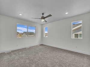 Carpeted spare room featuring a ceiling fan, a textured ceiling, and recessed lighting
