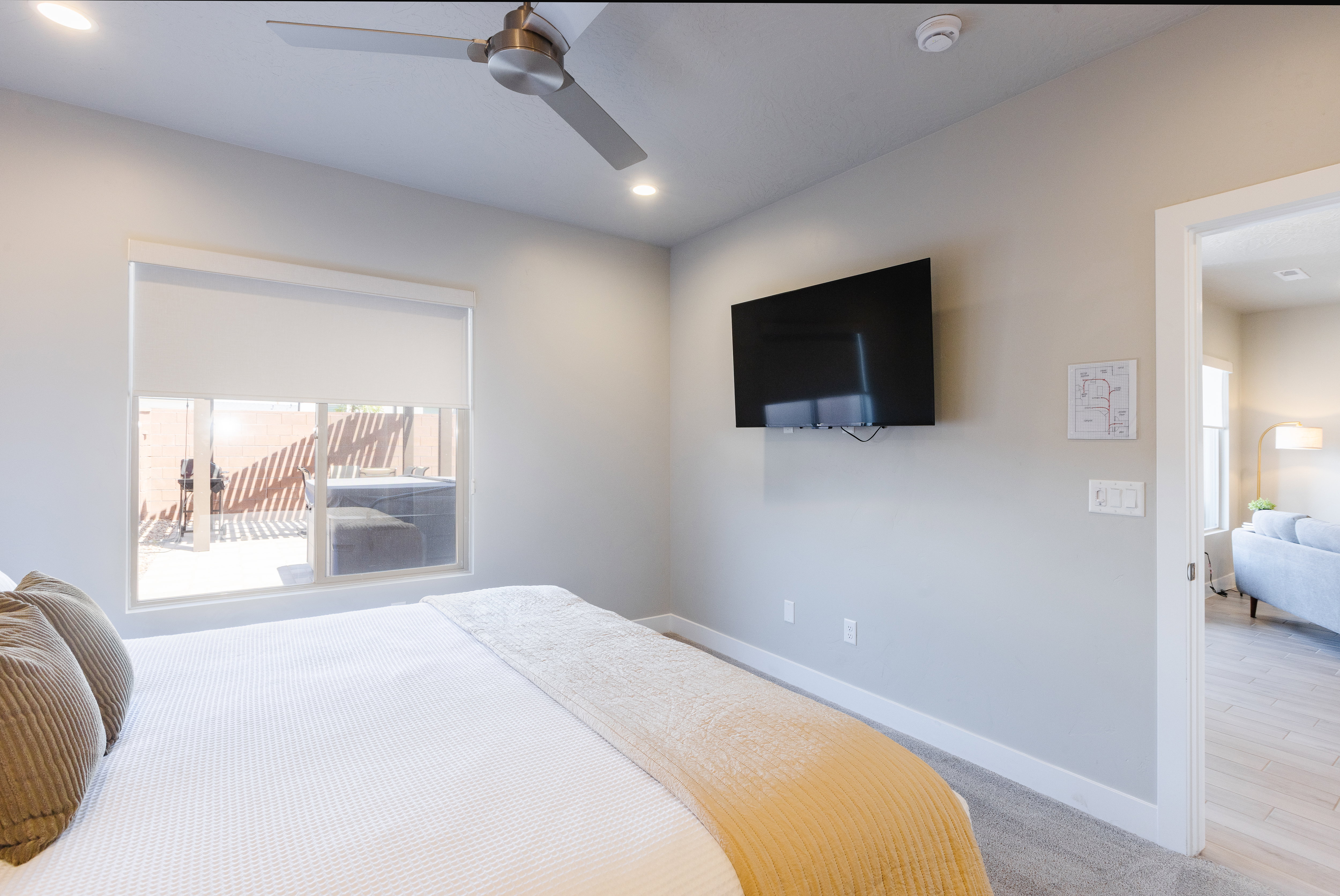 Bedroom featuring light colored carpet, ceiling fan, and recessed lighting