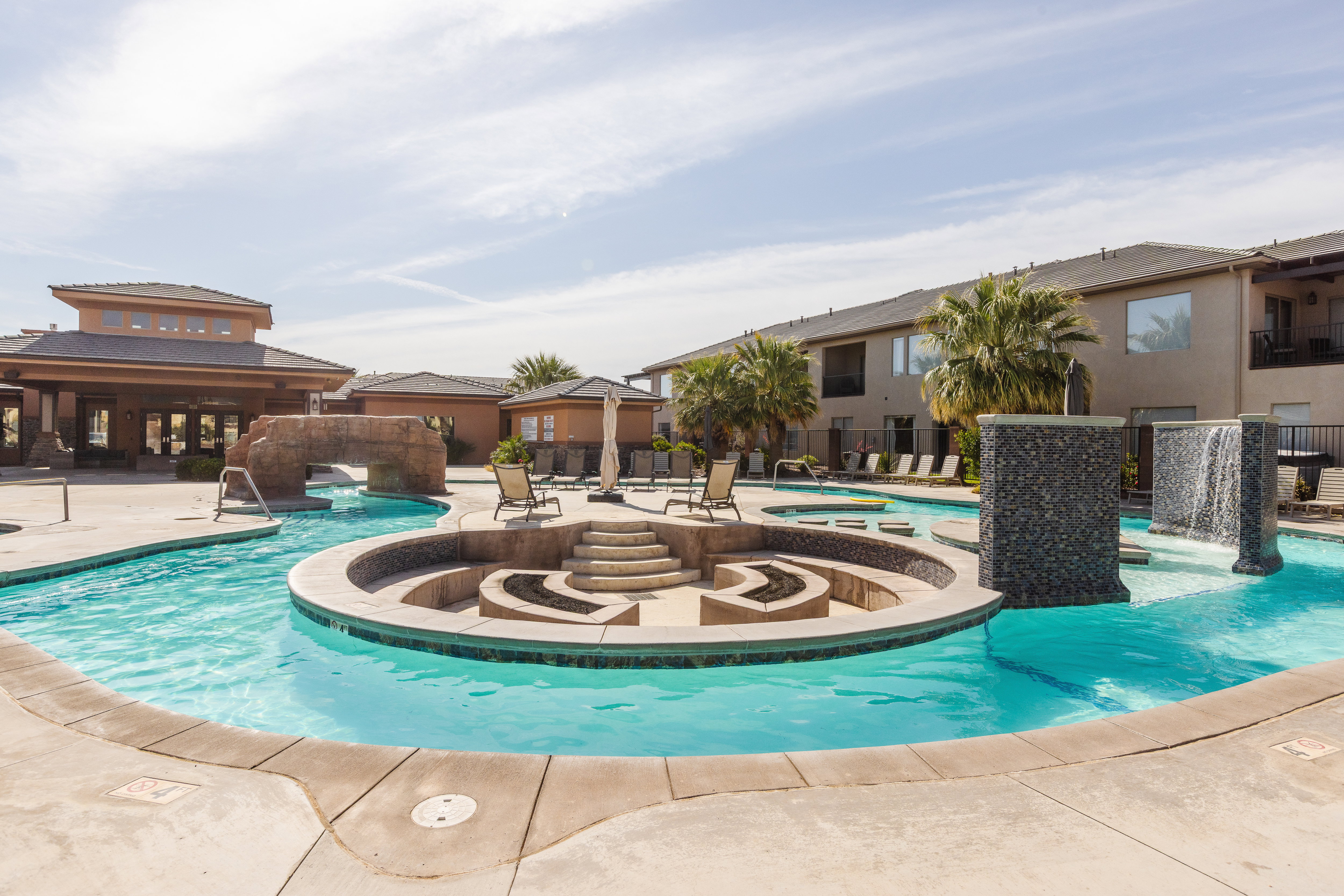 Community pool with a patio and a hot tub